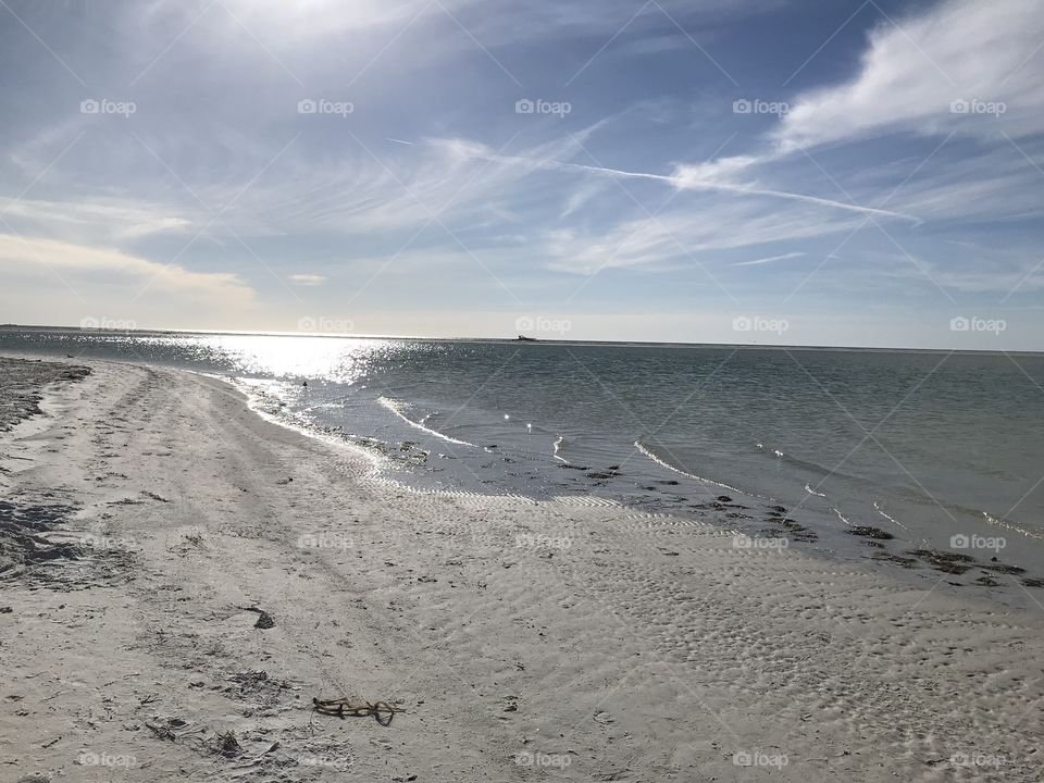 Sea and sand in Florida with a stunning sun in the back.
