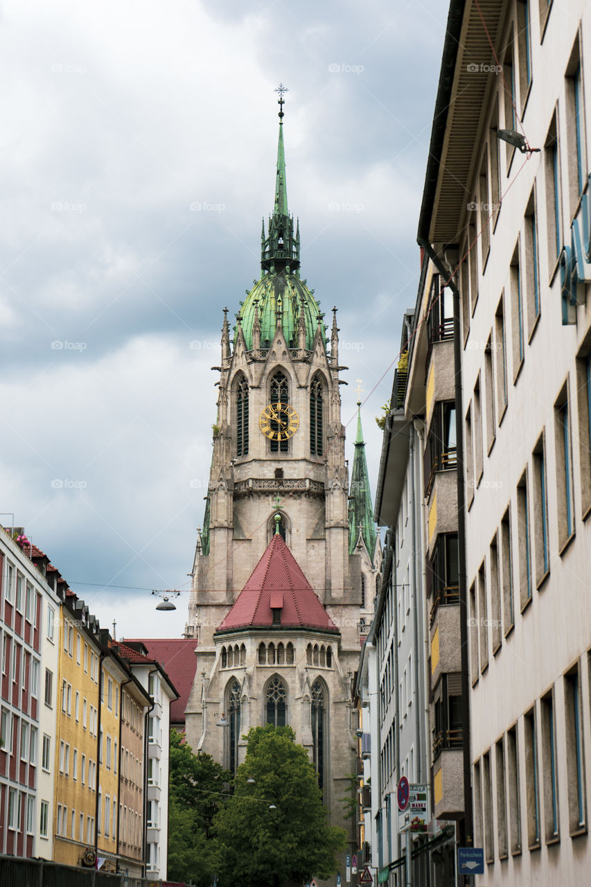 Bell tower of a church in Monaco of Bavaria. Check through the trees.