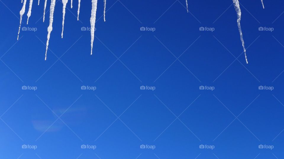 Icicle formations, from frozen dripping water in winter