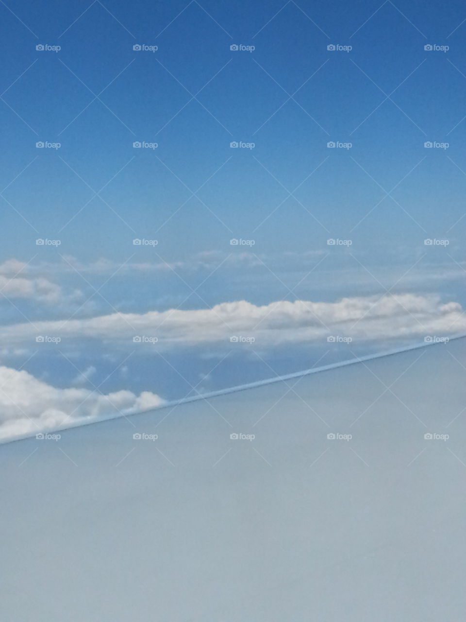 Above the clouds. High in the sky flying home to Hawaii