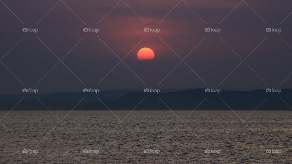 Red sun over the coast