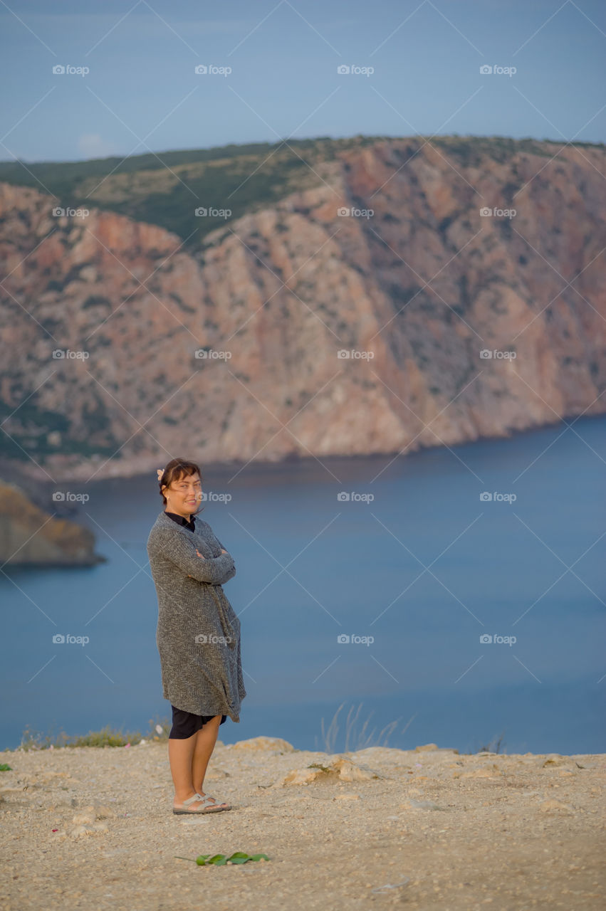 Sevastopol cape Fiolent girl stands against a very beautiful mountain landscape