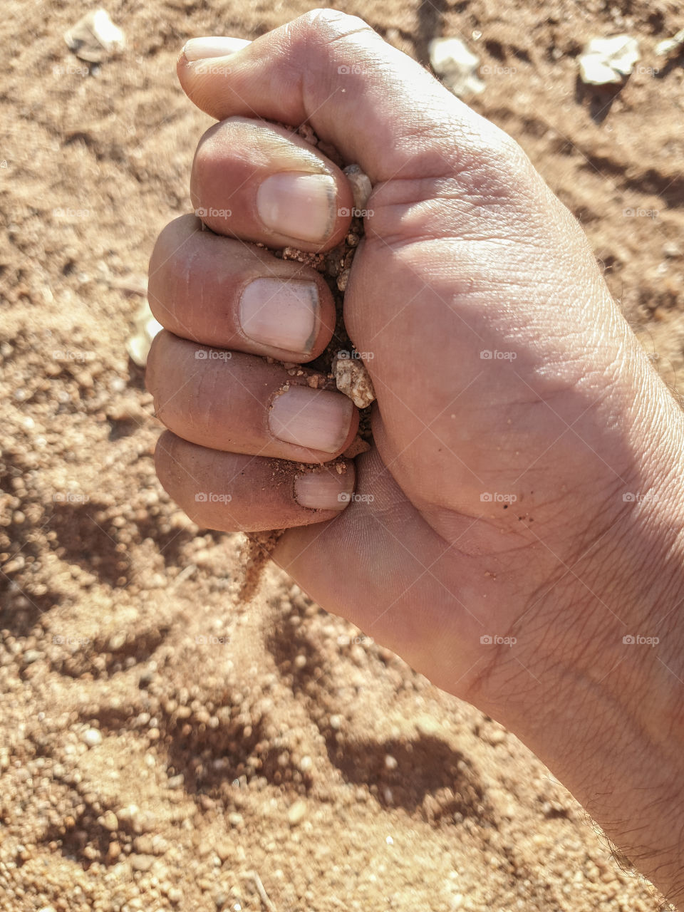 hand with sand falling out the bottem
