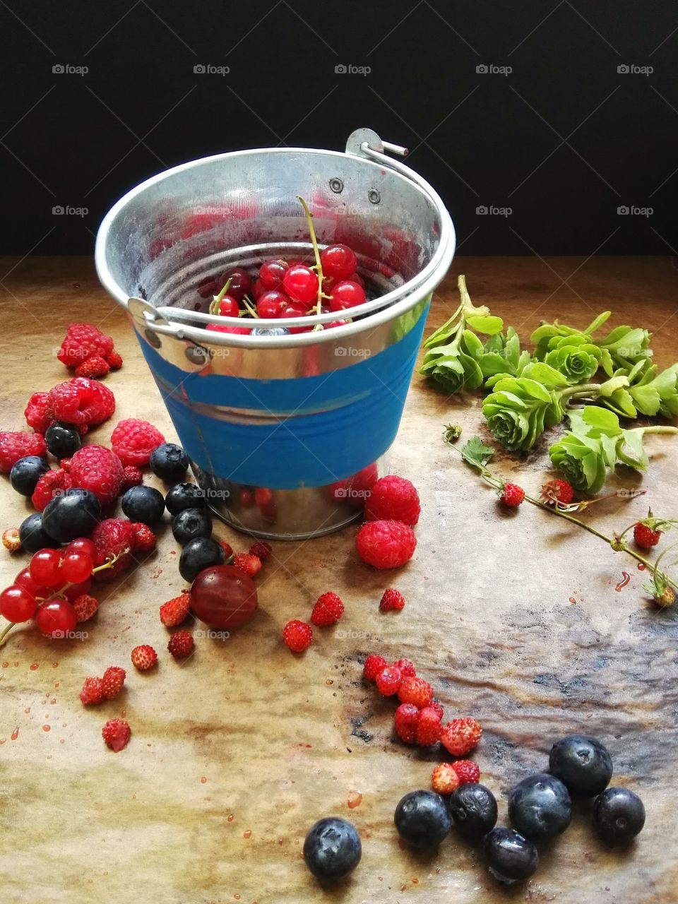Berries in blue metal bucket