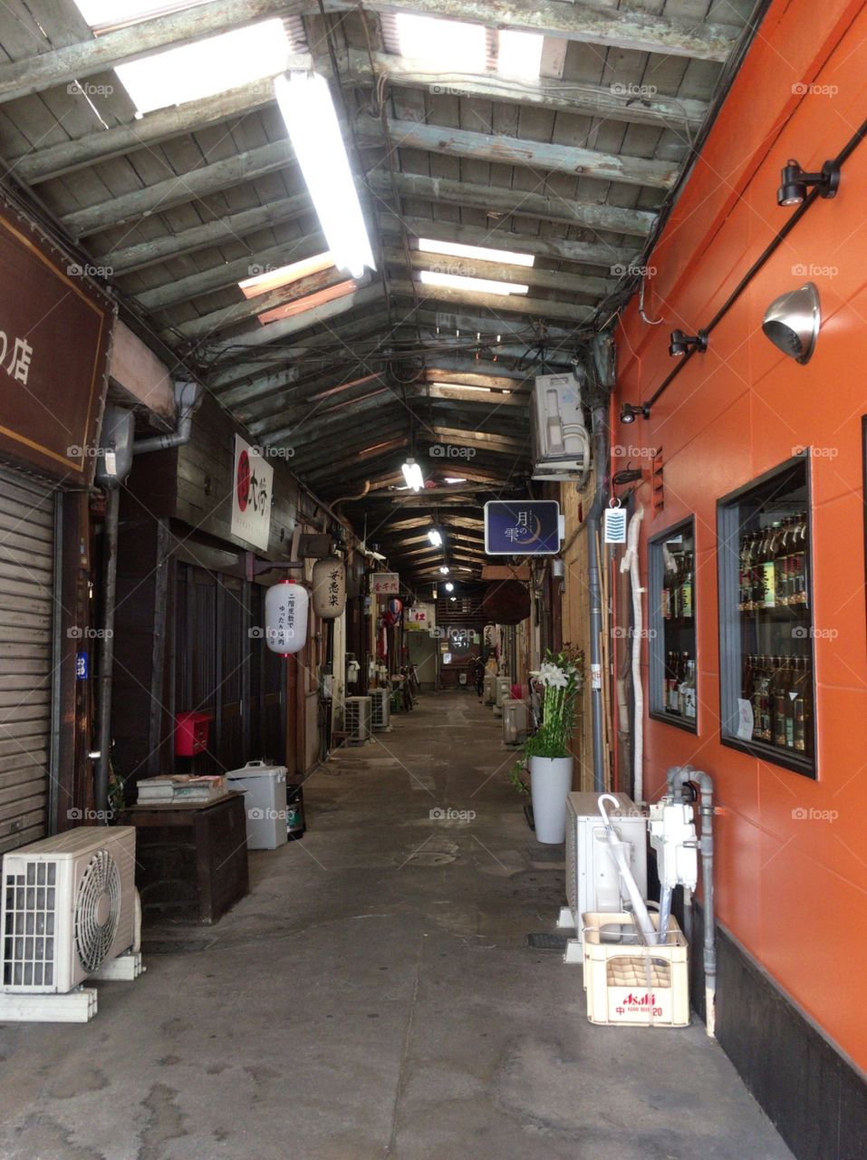 There are small bars and shops in the alley