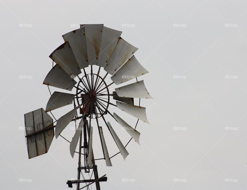 circular shape of a windmill against cloudy sky