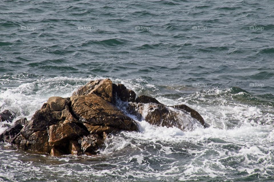 waves crashing on rocks