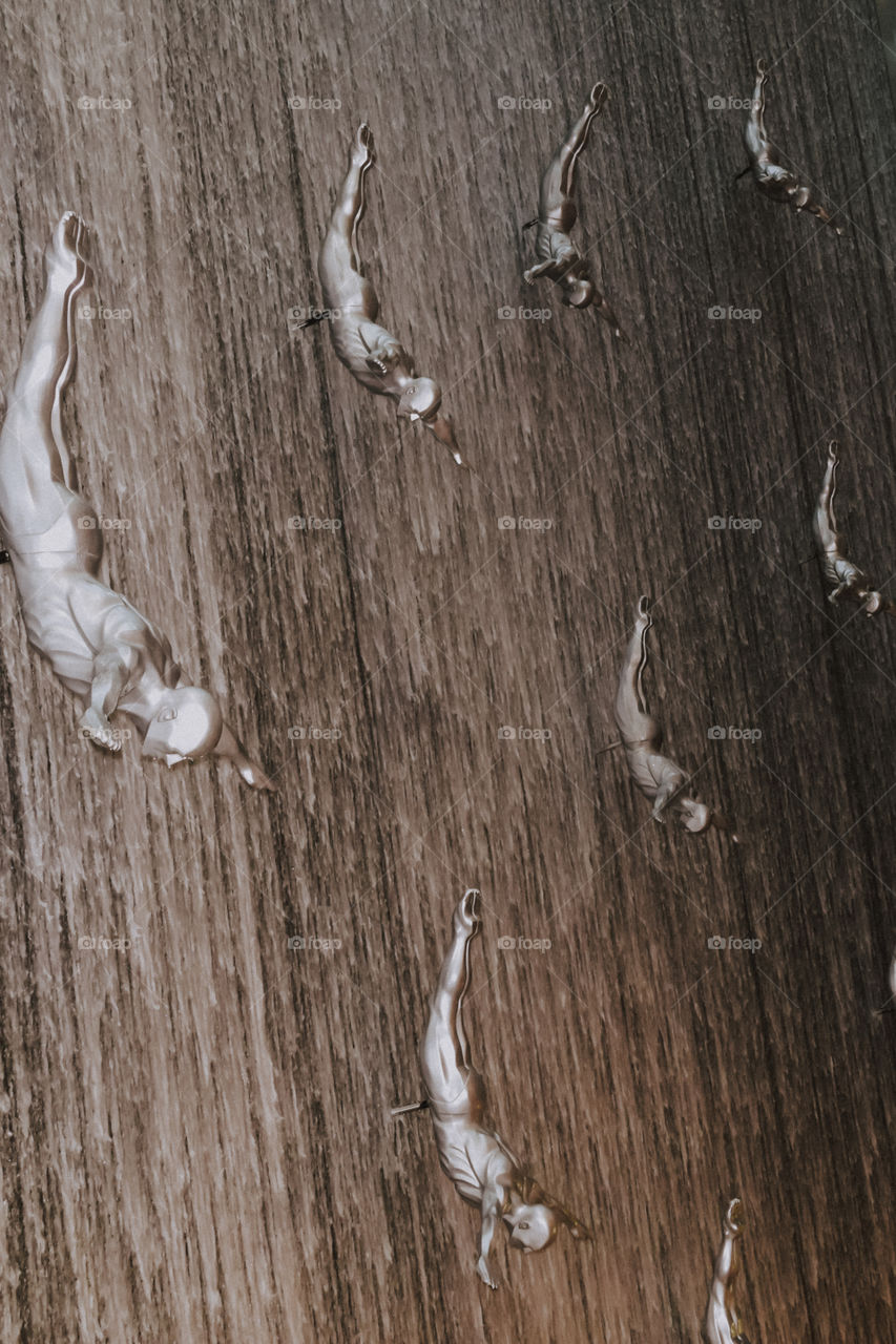 A group of adventurous athletic young adult men falling down. Abstract pattern texture frame background concept.