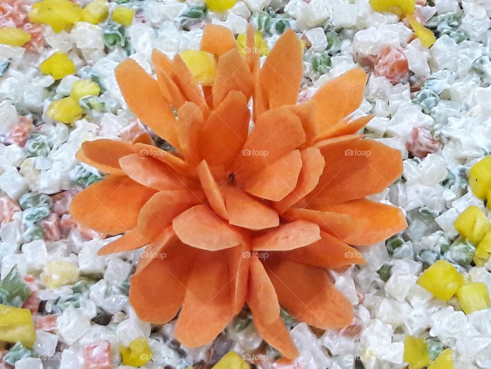 orange carrot multi petal flower salad dressing with mayonnaise and mixed vegetables