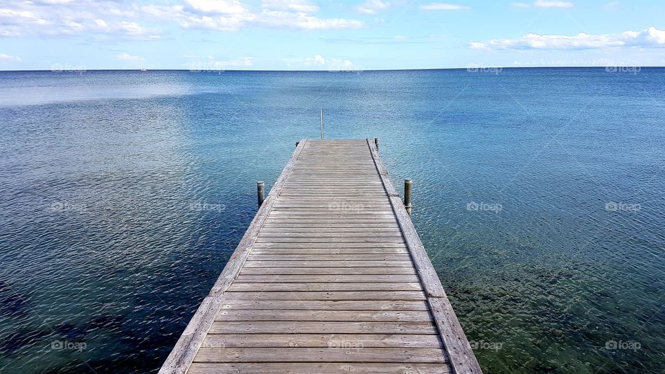 footbridge in the clear blue water of the sea