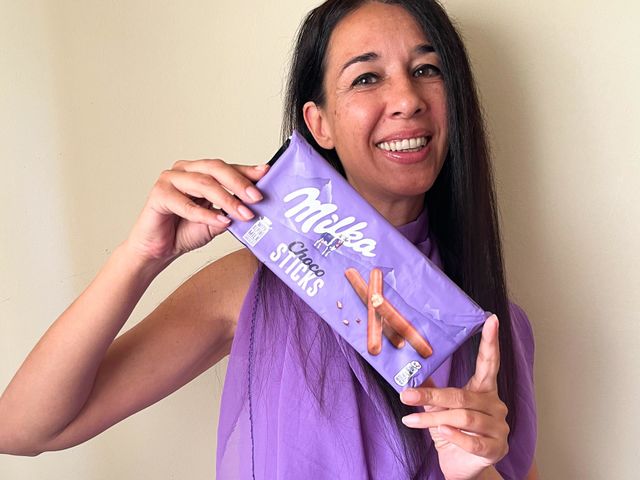 Energetic, Light-Hearted Portrait of Beautiful Smiling Woman with Milka Chocolate Sticks