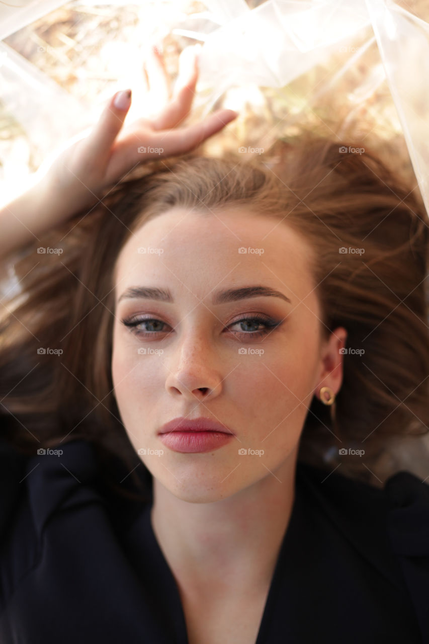 portrait photo of a young woman with bright makeup