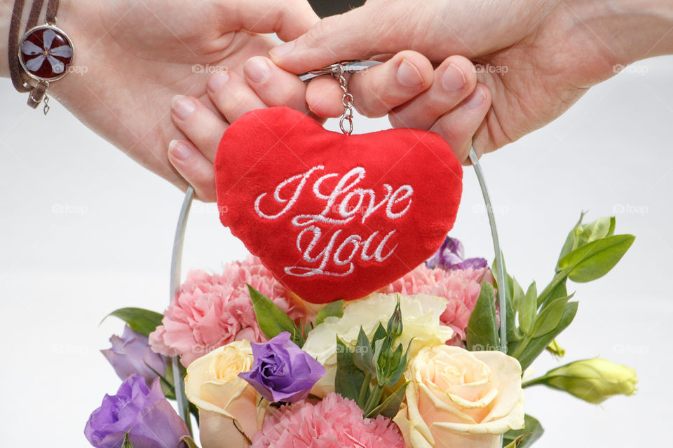 heart and flowers in hands