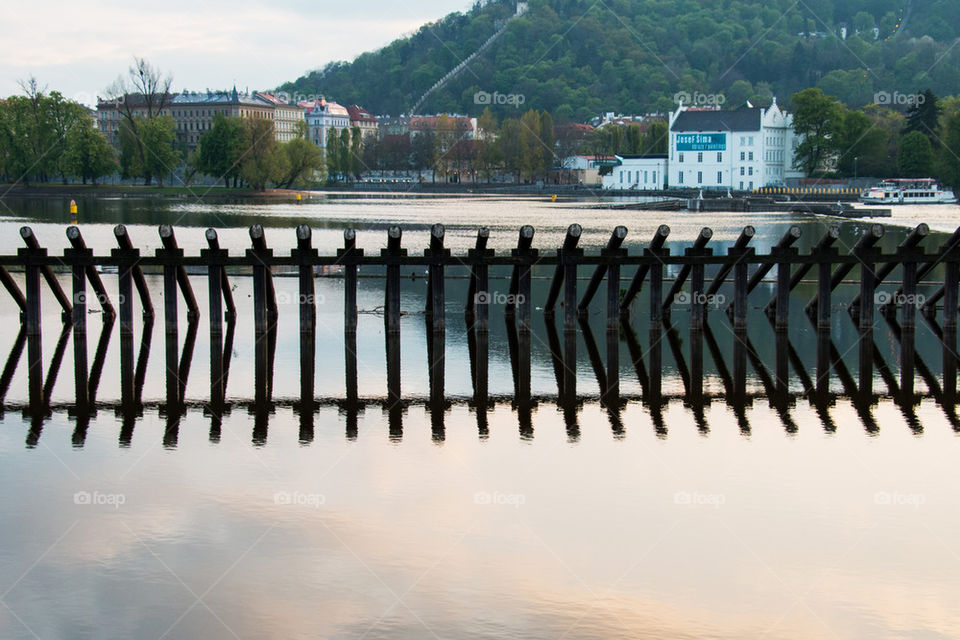 Reflection of posts in vlatva river