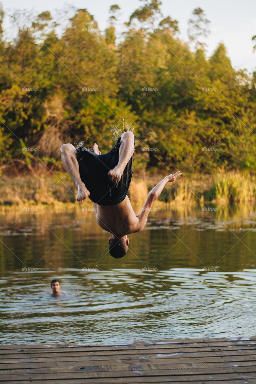 Boy jumping in the river