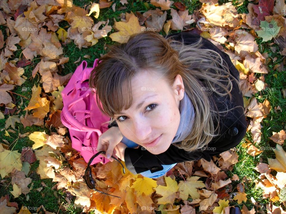 A girl in the autumn leaves