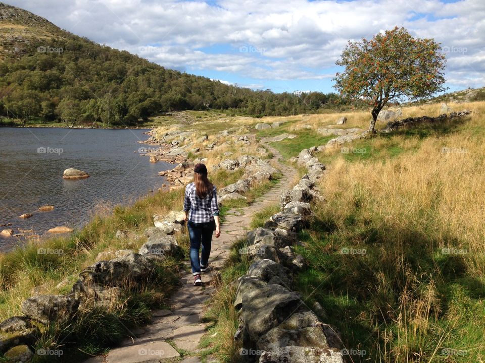 Hiking Day in Stavanger . Girl hiking up a trail in the mountains around Dalsnuten, Stavanger, Norway