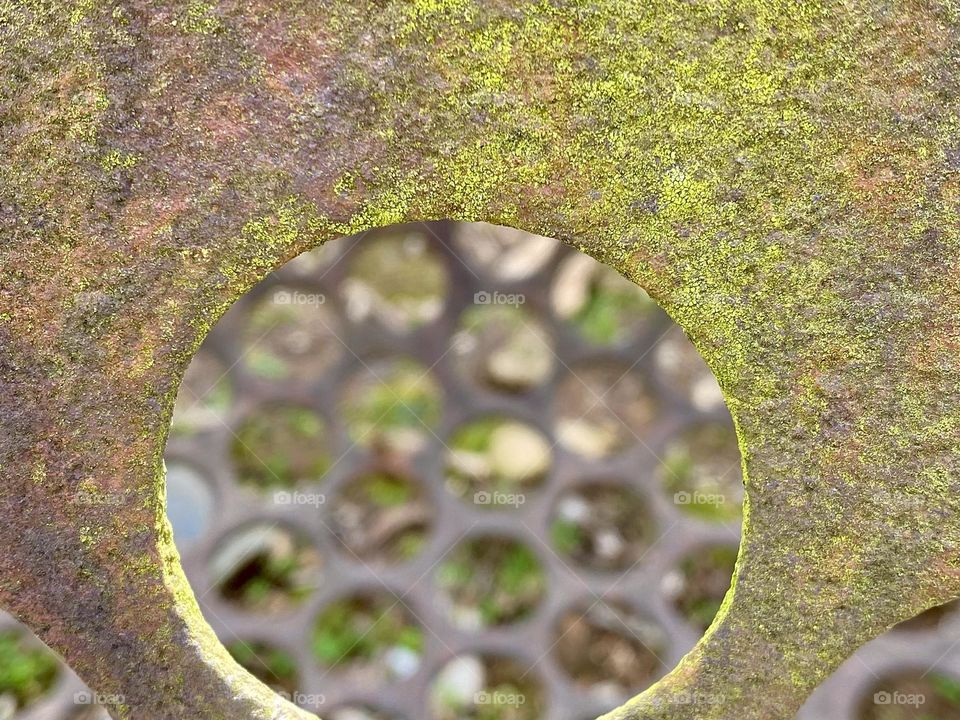 Rust and lichen growing on a metal sieve that sorted crushed rock at a quarry