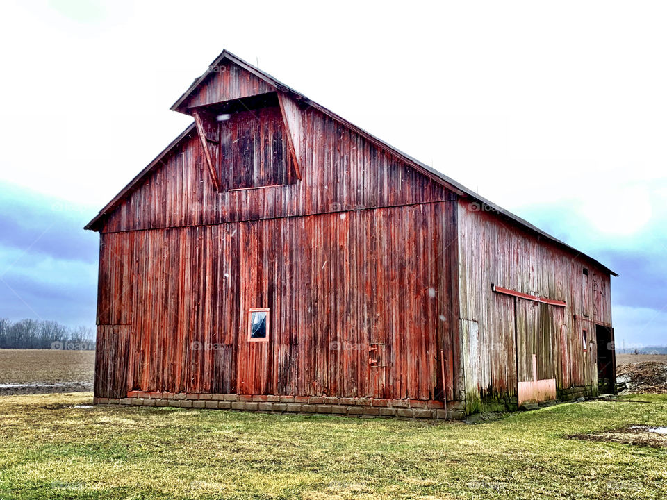 Old red Indiana barn on a snowy winter day 