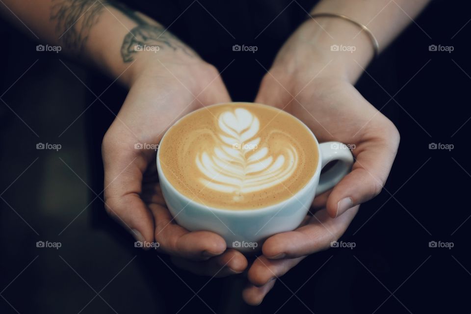 Lady holding a latte.