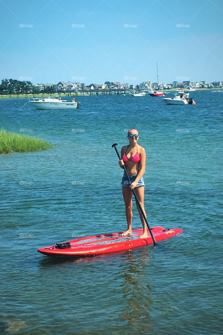 Photo of myself paddleboarding while on vacation in Narragansett, Rhode Island.