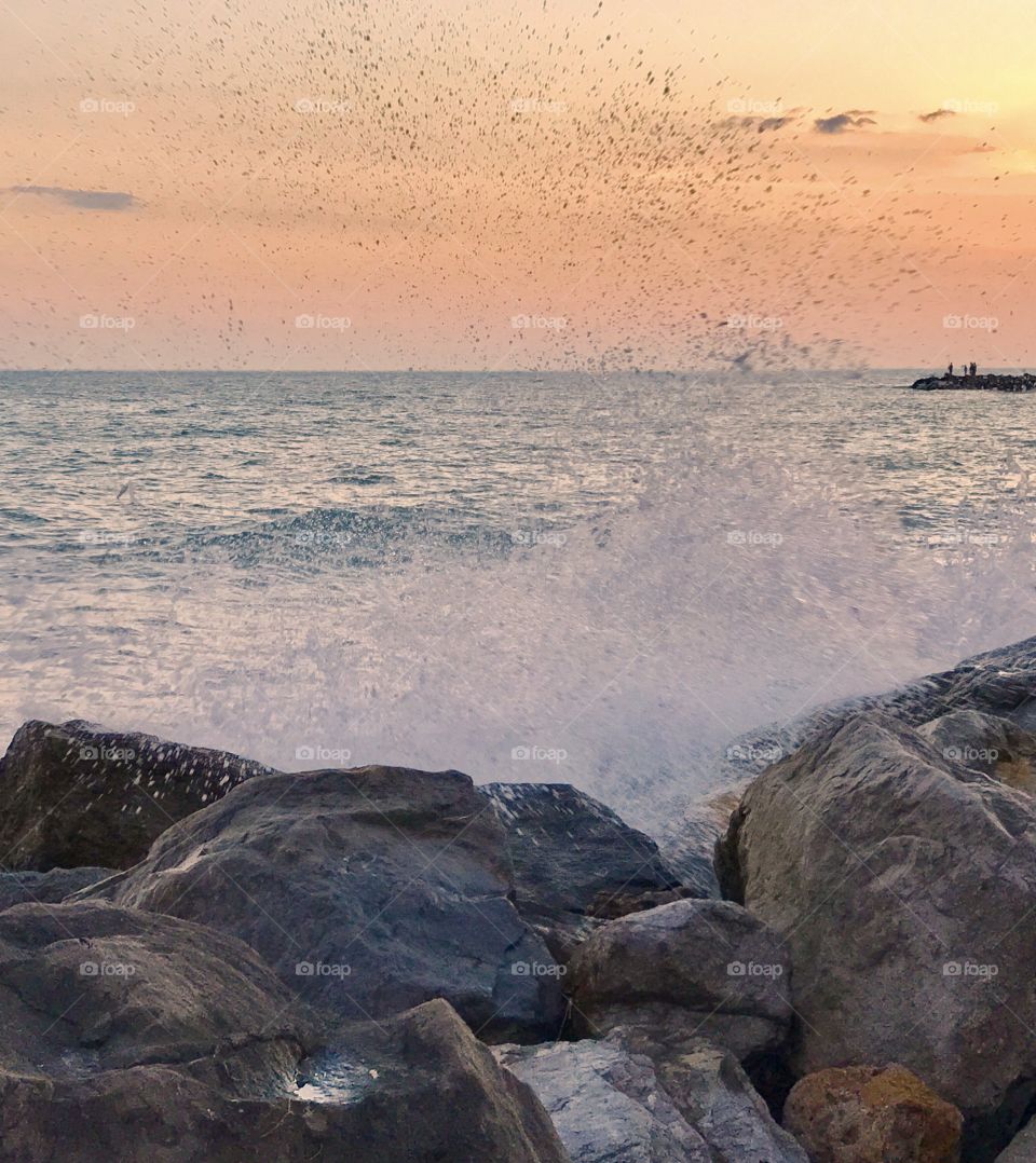 Water splashing in the sea at sunset