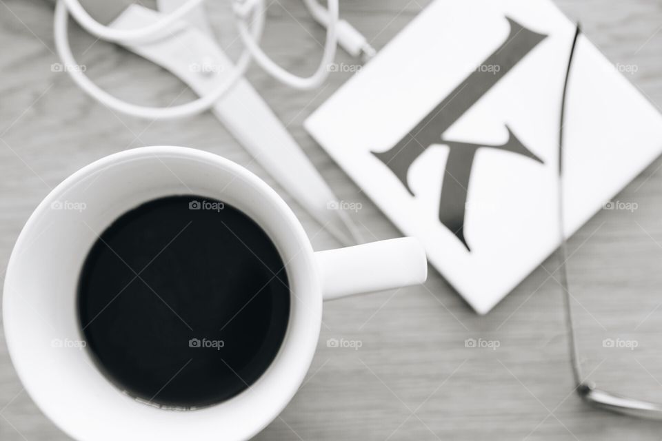 Overhead shot . Black coffee in a mug and the letter k 