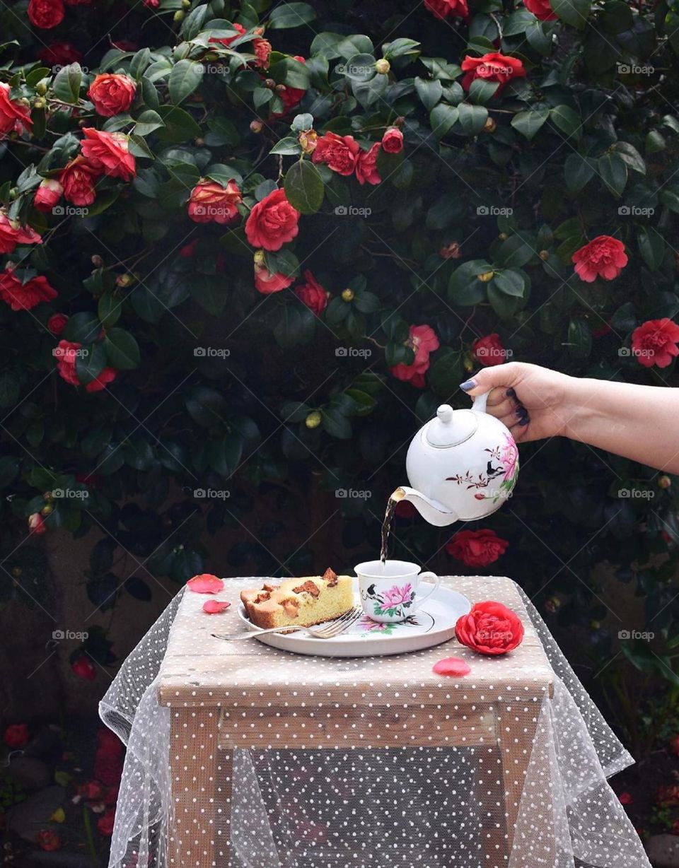 A cup of happiness beside beautiful roses