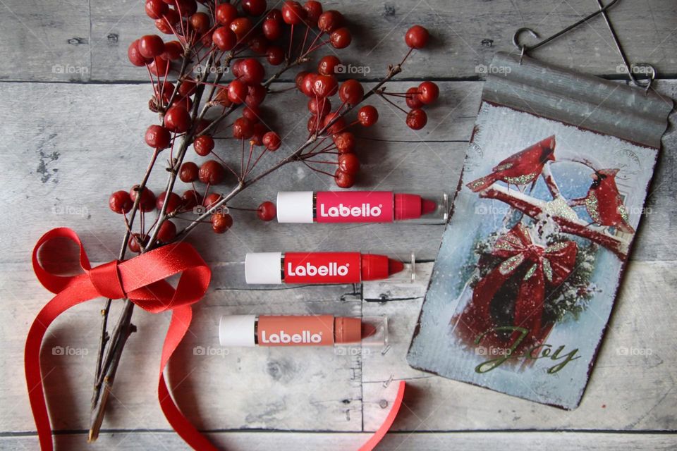 Lebello lipstick flat lay with berries and metal accessories