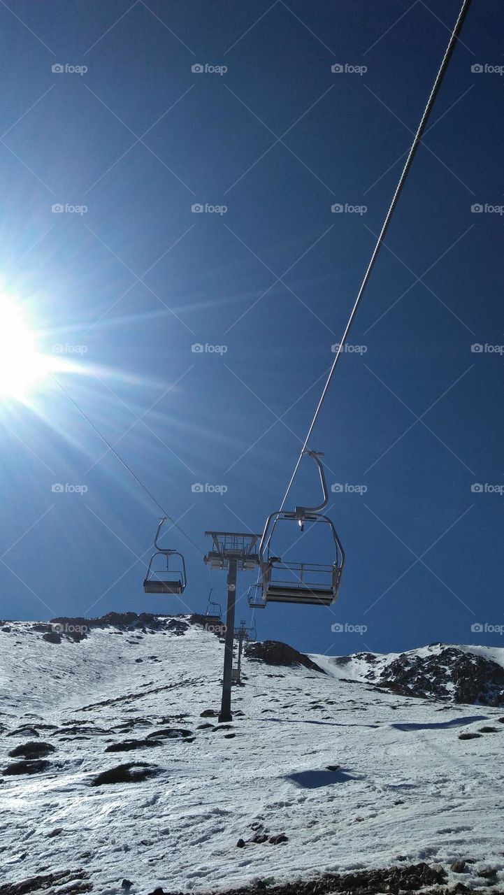 Sunshine cuts through mountain snow.