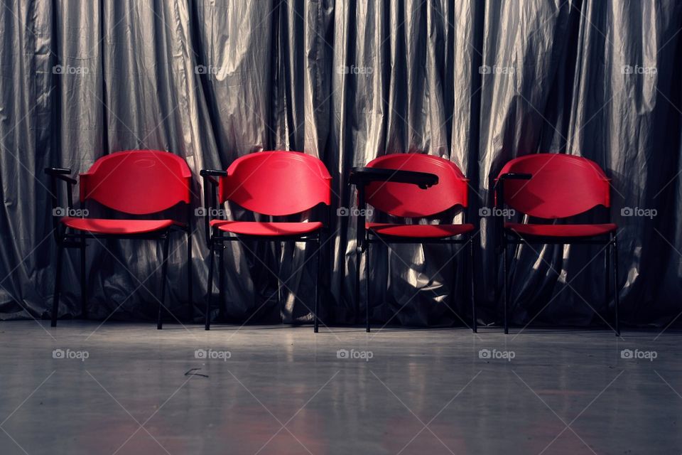 four empty red chairs