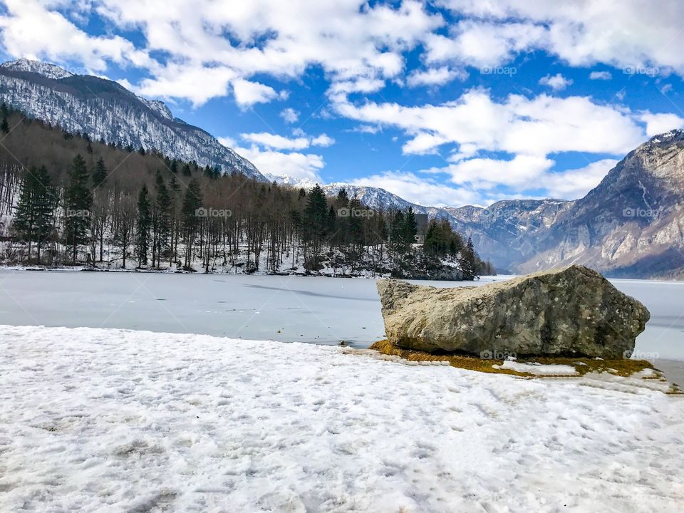 View of frozen lake and mountains