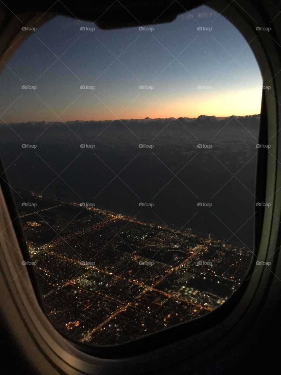 Airplane view - city to ocean. 