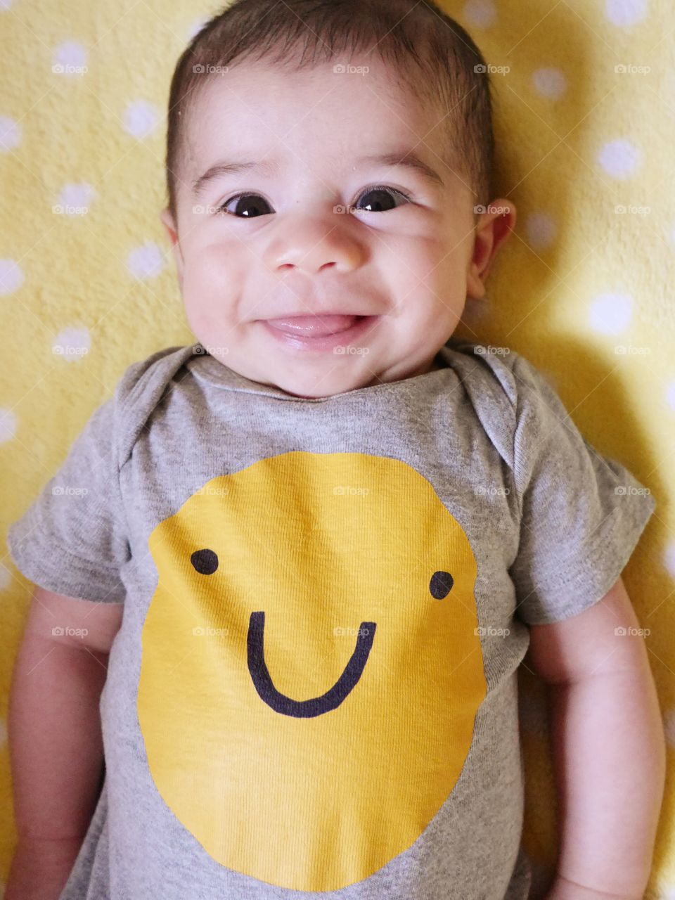 Elevated view of cute smiling baby boy