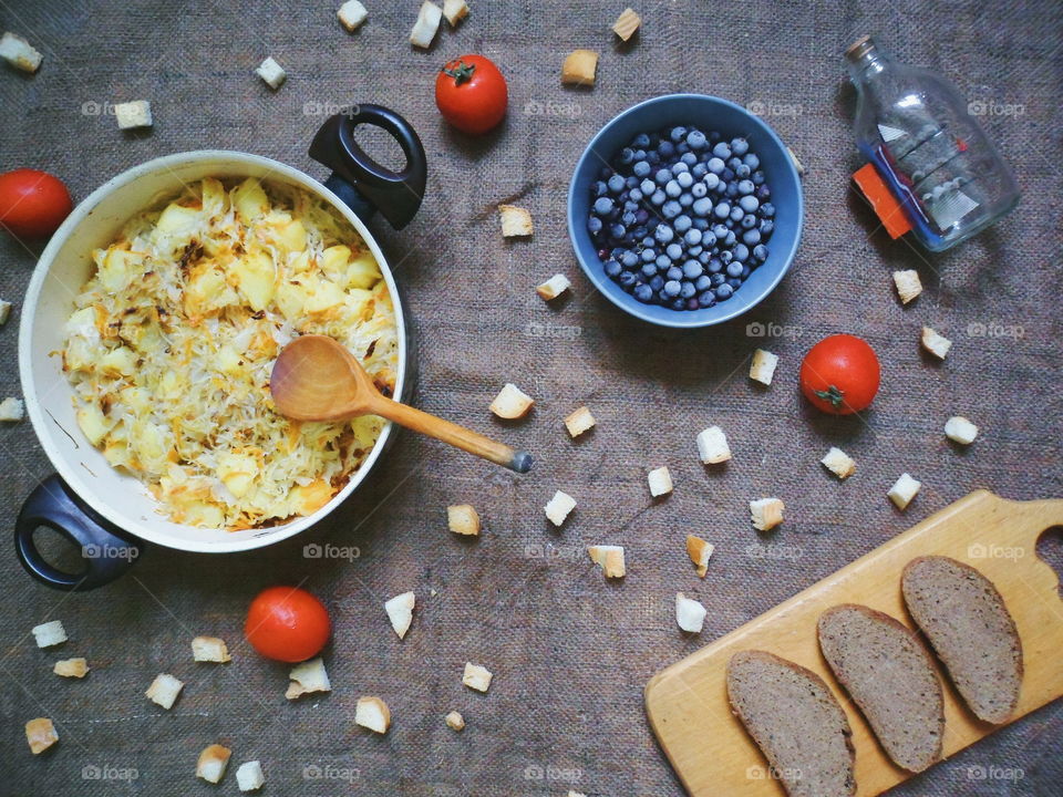 stewed potatoes, frozen currants, bread, tomatoes on the table