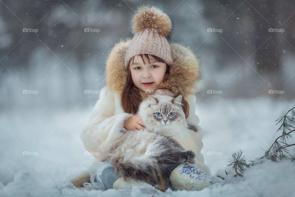 Little girl portrait with cat, winter outdoor 