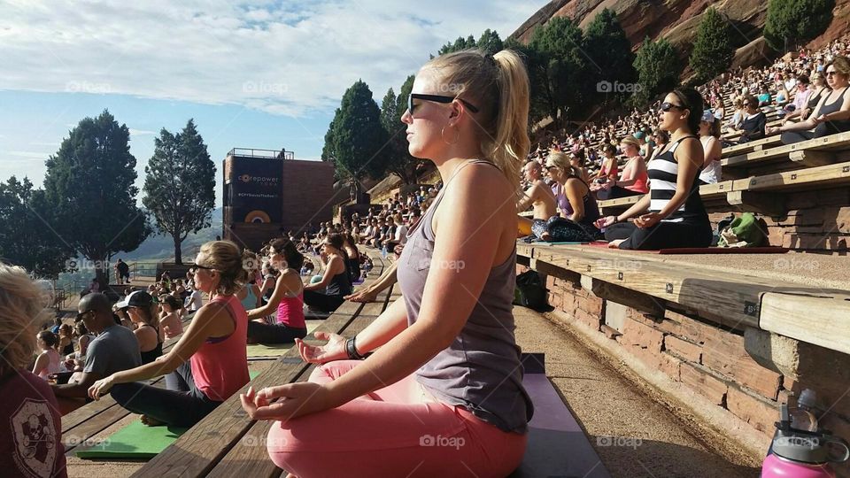 Group of women meditating in yoga pose at outdoors