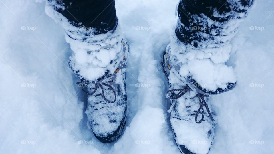 Low section of man standing in snow