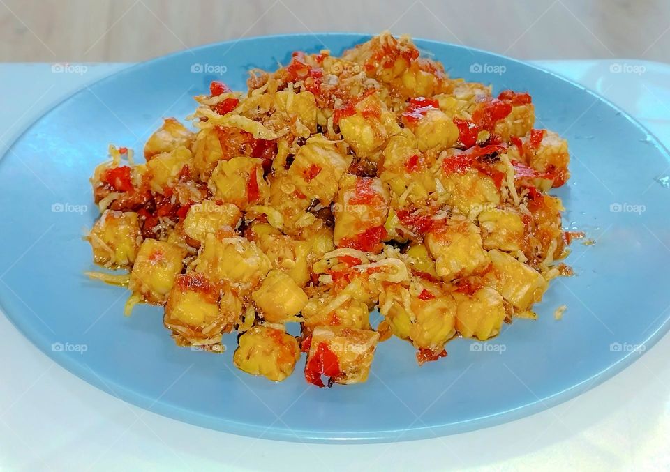 Indonesian special food, fried tempeh, fried anchovies chili sauce on a plate