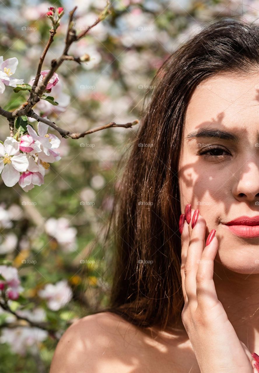 beautiful woman in spring blossom trees