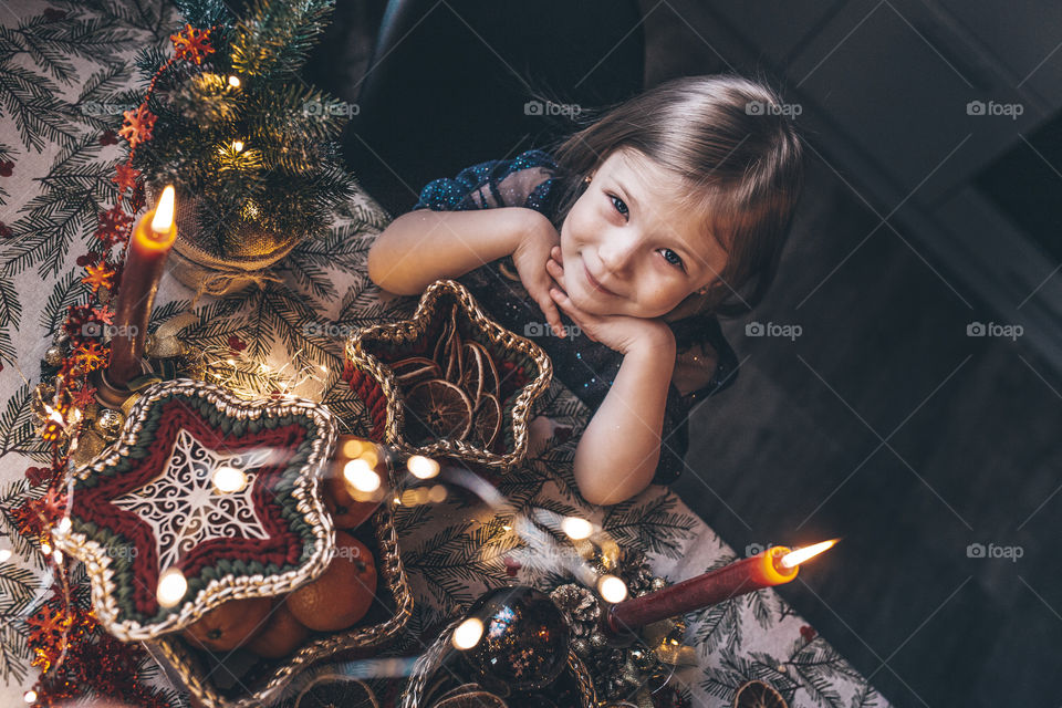 a girl in an elegant dress sits at the Christmas table