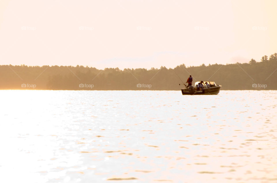 Man fishing on his boat on Lake Winnepesaukee in New Hampshire