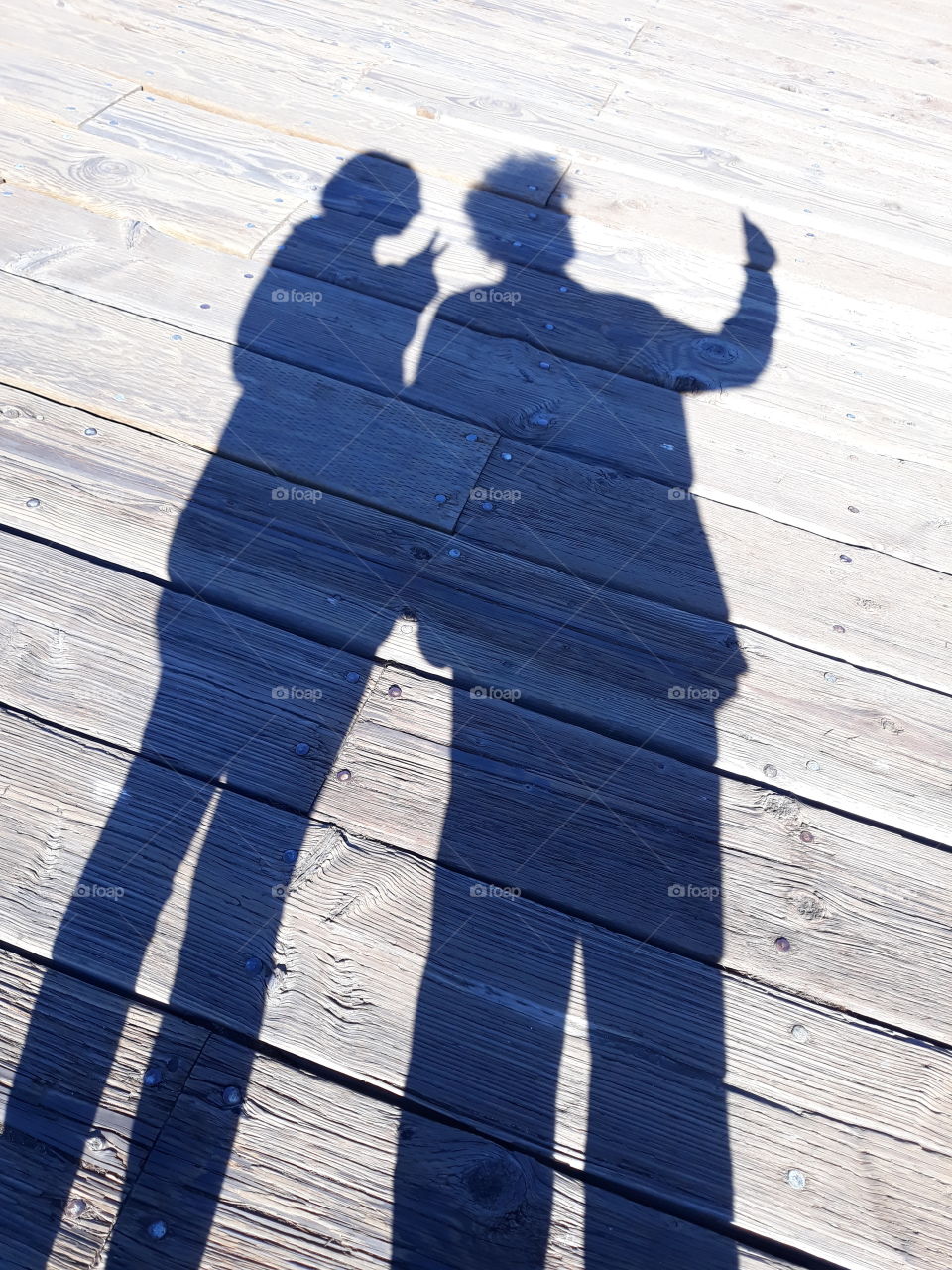 People always take selfies on their phones, but I wanted to capture how they look to others. The sun made this shadow perfect, in which we can see and imagine this action of taking a selfie happening before our very eyes