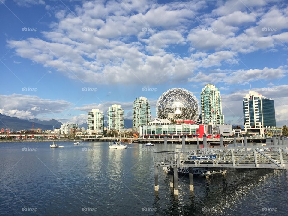 Harbour view of Science World with north shore mountains in the back drop in a beautiful fall day in Vancouver, British Columbia 