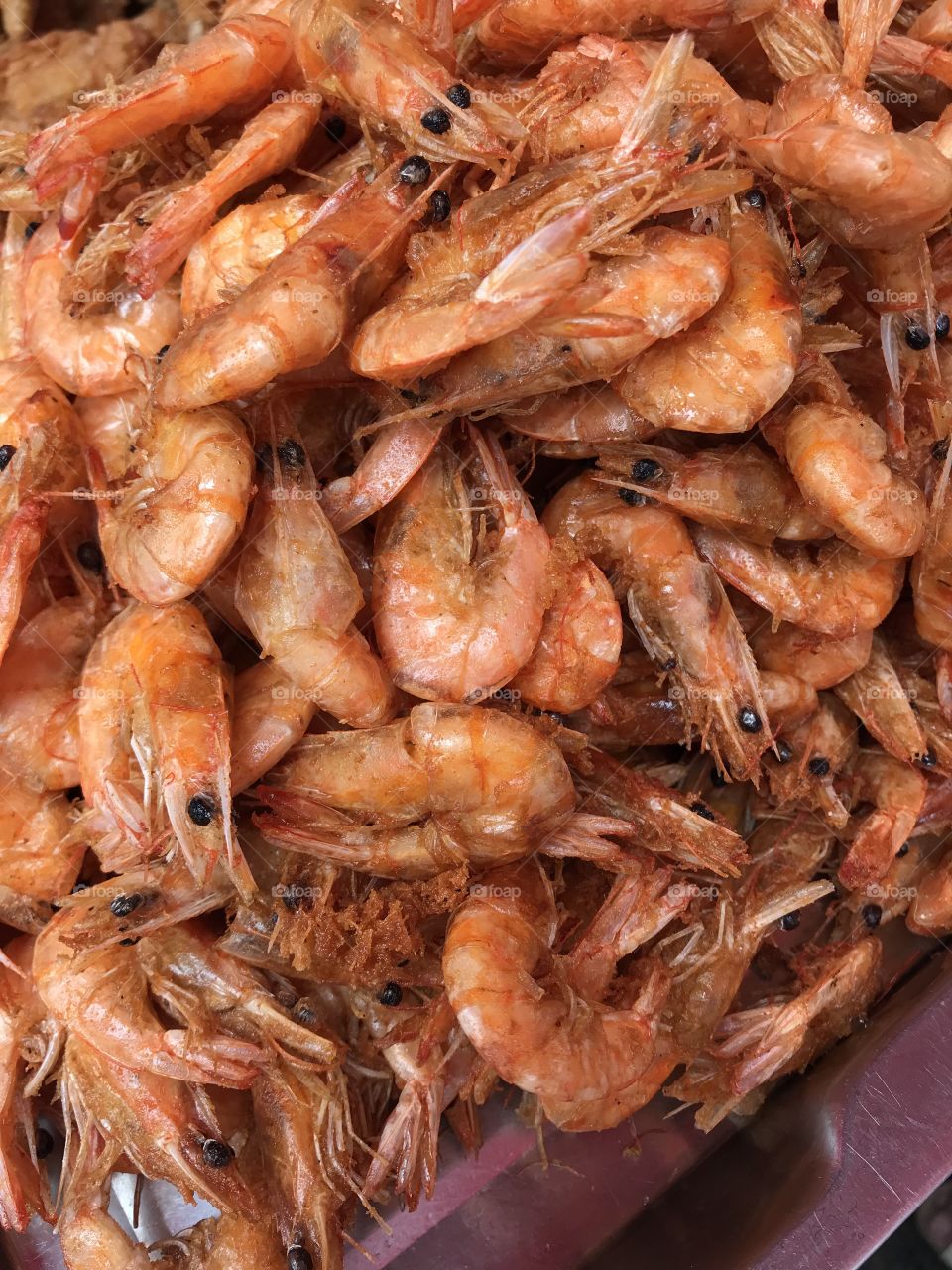 Street food of Thailand, Fried shrimps in hot oil for the appetizer or snack.