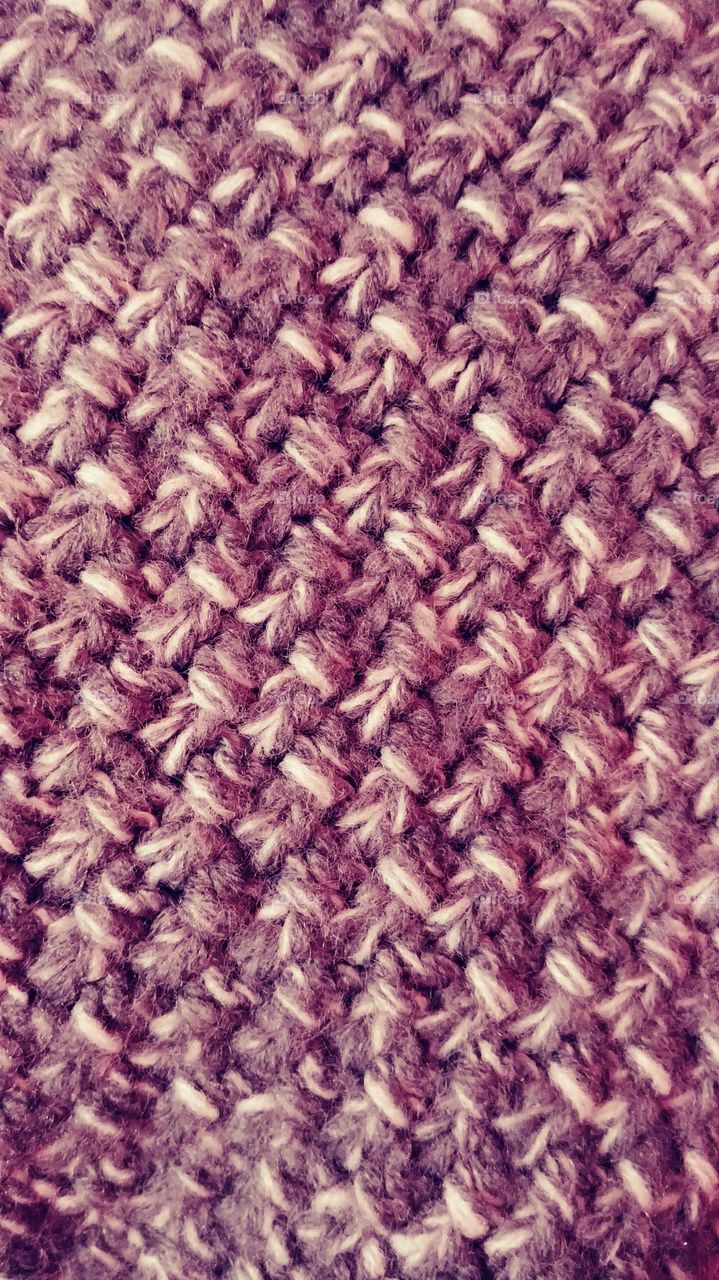 close up of a maroon woven blanket