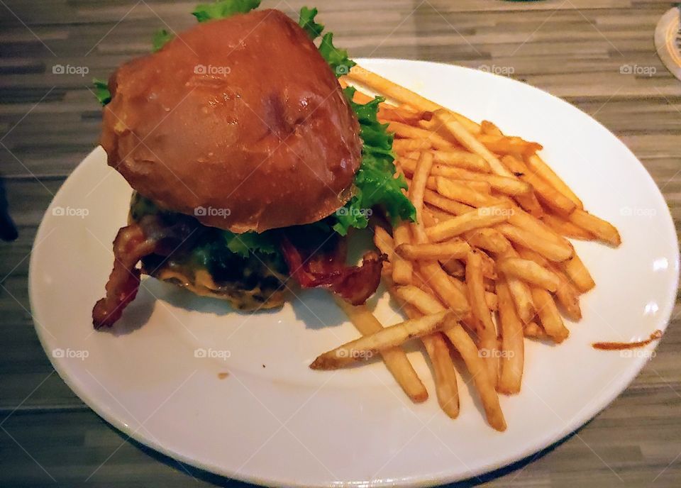 a delishous Smitty's burger and fries,tasty, big, geasy