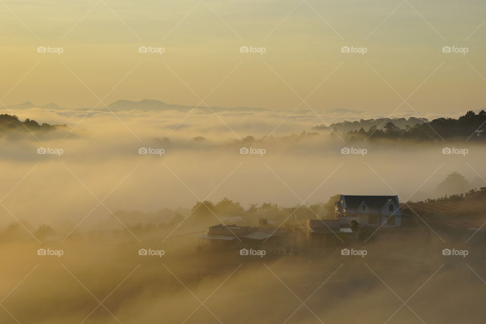 countryside houses in foggy morning