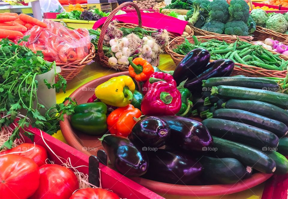 Fresh organically grown vegetables in market stall ready for sale at farmers market in France.