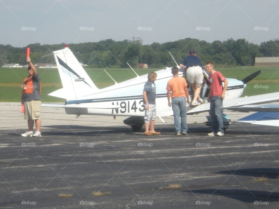 Passengers boarding plane and preparing for takeoff